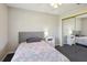 Well-lit bedroom featuring ceiling fan, plush carpet, and mirrored closet doors at 10367 Sw 45Th Ave, Ocala, FL 34476