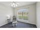 Cozy bedroom with a comfortable chair, a large window, and neutral-toned walls at 10367 Sw 45Th Ave, Ocala, FL 34476