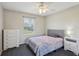 Bedroom with ceiling fan, soft carpet and plenty of natural light from the window at 10367 Sw 45Th Ave, Ocala, FL 34476