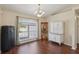 Elegant dining room with hardwood floors, a modern chandelier, and a large window with outside views at 10367 Sw 45Th Ave, Ocala, FL 34476