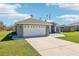 Spacious two-car garage with modern doors and clean concrete driveway at 10367 Sw 45Th Ave, Ocala, FL 34476