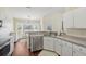 Bright kitchen with white cabinets, stainless steel appliances, and a casual dining area with a view at 10367 Sw 45Th Ave, Ocala, FL 34476