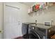 Laundry room equipped with modern appliances and a convenient wire shelf for storage at 10367 Sw 45Th Ave, Ocala, FL 34476