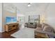 Cozy living room featuring hardwood floors, comfortable sofas, and a large window offering a pleasant view at 10367 Sw 45Th Ave, Ocala, FL 34476