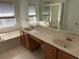 Bright bathroom featuring dual sinks, spacious countertops, a soaking tub and glass enclosed shower at 1352 Royal Saint George Dr, Orlando, FL 32828