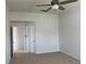 Carpeted bedroom with ceiling fan, closet, and ensuite bathroom entrance at 1352 Royal Saint George Dr, Orlando, FL 32828