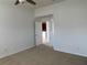 Bright bedroom features neutral carpeting, base trim, and door leading to other rooms at 1352 Royal Saint George Dr, Orlando, FL 32828
