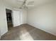 This bedroom features neutral carpeting, ceiling fan, and closet, offering a serene retreat at 1352 Royal Saint George Dr, Orlando, FL 32828