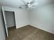 Neutral bedroom with ceiling fan, carpet, and door that leads to other rooms in the home at 1352 Royal Saint George Dr, Orlando, FL 32828