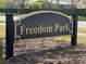 Freedom Park community sign with gold lettering, black frame, and manicured lawn at 1352 Royal Saint George Dr, Orlando, FL 32828