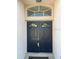 An elegant double door entry featuring an arched transom window at 1352 Royal Saint George Dr, Orlando, FL 32828