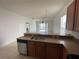 Spacious kitchen with a stainless steel dishwasher and access to the living area at 1352 Royal Saint George Dr, Orlando, FL 32828
