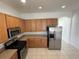 Modern kitchen featuring stainless steel appliances, plenty of cabinet space, and tile flooring at 1352 Royal Saint George Dr, Orlando, FL 32828