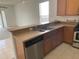 Functional kitchen bar area with stainless steel appliances and a view to the living space at 1352 Royal Saint George Dr, Orlando, FL 32828