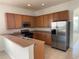 A bright kitchen with stainless steel appliances and wooden cabinets for storage at 1352 Royal Saint George Dr, Orlando, FL 32828