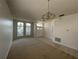 Spacious living room with carpet and tile flooring, chandelier and ample natural light at 1352 Royal Saint George Dr, Orlando, FL 32828
