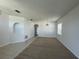 Large living room with both carpet and tile flooring, neutral walls and decorative lighting fixture at 1352 Royal Saint George Dr, Orlando, FL 32828