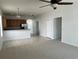 Comfortable living room with carpet and tile flooring, adjacent to an open-concept kitchen at 1352 Royal Saint George Dr, Orlando, FL 32828