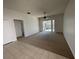 Spacious living room featuring carpet and sliding glass doors to an enclosed lanai at 1352 Royal Saint George Dr, Orlando, FL 32828