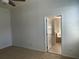 Main bedroom with a ceiling fan and bathroom entrance at 1352 Royal Saint George Dr, Orlando, FL 32828