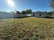 Exterior of home showing a spacious, grassy backyard surrounded by a tall fence at 137 W G H Washington St, Apopka, FL 32703