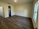 Spacious bedroom with wood-look floors and a large window for natural light at 137 W G H Washington St, Apopka, FL 32703