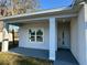 Welcoming entrance with modern door, sturdy pillars, and a cozy porch area, perfect for relaxing at 137 W G H Washington St, Apopka, FL 32703