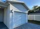 Close-up of a single-car garage with house number, complemented by a stone driveway at 137 W G H Washington St, Apopka, FL 32703