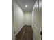A well lit hallway with wood-look flooring and white walls at 137 W G H Washington St, Apopka, FL 32703