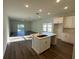 Open-concept kitchen with island, seamlessly connected to a spacious living area, perfect for entertaining at 137 W G H Washington St, Apopka, FL 32703