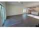 Bright open-concept living room with wood-look floors and sliding glass doors to patio at 137 W G H Washington St, Apopka, FL 32703