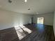 Spacious living room with vinyl plank flooring, natural light, and a seamless flow to outdoor spaces at 137 W G H Washington St, Apopka, FL 32703