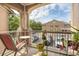 Balcony view with outdoor seating and plants, overlooking a parking lot and nearby building at 14316 Fredricksburg Dr # 507, Orlando, FL 32837