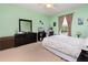 Bright bedroom with a ceiling fan, a large window, desk area and a full dresser for clothing storage at 14316 Fredricksburg Dr # 507, Orlando, FL 32837