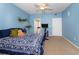 Blue bedroom features a bed, workout bike, and access to the bathroom via a separate entrance at 14316 Fredricksburg Dr # 507, Orlando, FL 32837