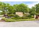 Capri at Hunter's Creek Condominiums sign surrounded by beautiful plants and foliage, creating a welcoming entrance at 14316 Fredricksburg Dr # 507, Orlando, FL 32837