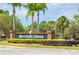 Hunter's Creek community entrance sign surrounded by lush landscaping with palm trees in the background at 14316 Fredricksburg Dr # 507, Orlando, FL 32837