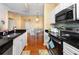 Well-equipped kitchen with black countertops, stainless steel appliances, and dining area access at 14316 Fredricksburg Dr # 507, Orlando, FL 32837