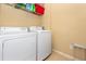 Spacious laundry room equipped with a washing machine, dryer, and overhead storage shelving at 14316 Fredricksburg Dr # 507, Orlando, FL 32837