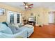 Inviting living room with a ceiling fan and French doors leading to a balcony at 14316 Fredricksburg Dr # 507, Orlando, FL 32837