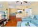 Comfortable living room featuring wood floors and an adjacent dining area at 14316 Fredricksburg Dr # 507, Orlando, FL 32837