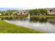 Scenic view of a pond with a fountain in a tranquil residential community at 14316 Fredricksburg Dr # 507, Orlando, FL 32837