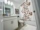 Clean bathroom with a white single vanity, floral shower curtain and decor at 15173 Summer Harvest St, Winter Garden, FL 34787