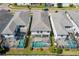 An aerial shot of the property showcasing a private screened-in pool and well-manicured backyard at 1551 Flange Dr, Davenport, FL 33896