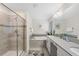 Bright bathroom featuring a shower, soaking tub, dual sinks, white cabinetry, and grey quartz countertop at 1551 Flange Dr, Davenport, FL 33896