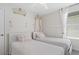 Charming bedroom featuring two twin beds and decorative details like crown molding and whimsical wallpaper at 1551 Flange Dr, Davenport, FL 33896