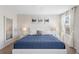 Bright bedroom with a white bedframe, blue comforter, three hanging artwork pieces, and white curtains at 1551 Flange Dr, Davenport, FL 33896