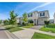 Beautiful two-story home with blue shutters, a well-kept lawn, and a paved driveway at 1551 Flange Dr, Davenport, FL 33896