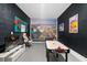 Entertainment room featuring an air hockey table, gaming chair and a mounted television on a dark wall at 1551 Flange Dr, Davenport, FL 33896