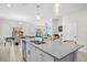 Open-concept kitchen with island seating and views of the dining and living areas at 1551 Flange Dr, Davenport, FL 33896